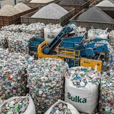 Baled plastic bottles in bulk bags at a recycling facility