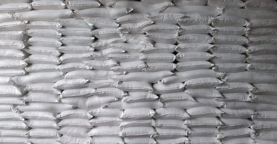 Warehouse wall of stacked PP woven bags